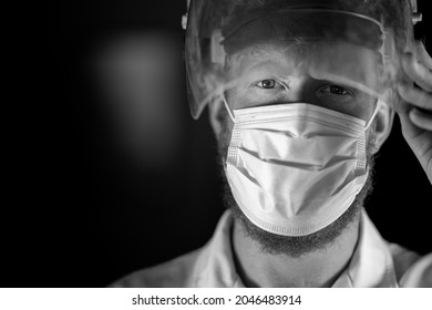 Covid Doctor And Health Care Worker, Putting On A Mask And Face Shield, While Wearing A Lab Coat And Gloves In Australia.