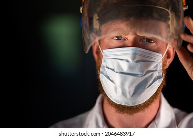 Covid Doctor And Health Care Worker, Putting On A Mask And Face Shield, While Wearing A Lab Coat And Gloves In Australia.