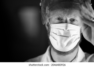 Covid Doctor And Health Care Worker, Putting On A Mask And Face Shield, While Wearing A Lab Coat And Gloves In Australia.