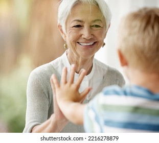 Covid, Family And Window With Grandma And Boy Touching Through Barrier For Prevention And Safety Showing Love, Care And Happiness. Quarantine, Coronavirus And Isolation With Senior Woman And Child