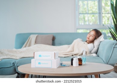 Covid First Aid Box Self Recover Health Care Of Woman Patient Fever, Cold Or Sick Her Sleep On Sofa. Customer Delivery Service From Hospital Online Clinic Retail Rx Drug Store In E-commerce Home Order