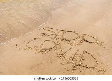 Covid free, stop Covid, safe beach and holiday, word written on the sand