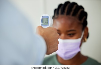 Covid, Healthcare And Woman Patient Getting Thermometer Check With A Compliance Officer During Consultation Or Appointment. Health, Hygiene Regulations And Wellness With A Female Wearing A Face Mask