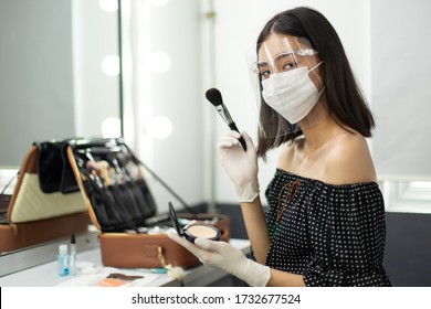 Covid New Normal Of Career Working With People, Make Up Artist Has To Wear Rubber Glove, Surgical Mask And Face Shield To Protect Both Herself And Customer. Young Asian Woman Look At Camera