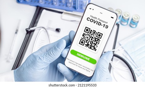 Covid passport doctor holding. Coronavirus vaccination certificate of immunity passport on smartphone screen with doctor stethoscope, syringe and medical equipment on hospital white background. - Powered by Shutterstock