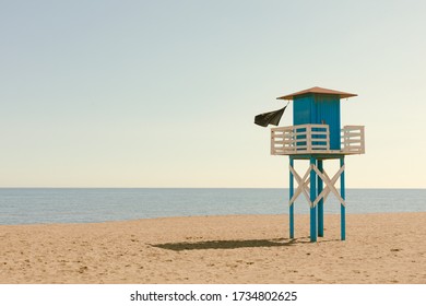 Covid Phase 1 In Málaga, Spain. A Closed And Solitary Beach With Black Flag