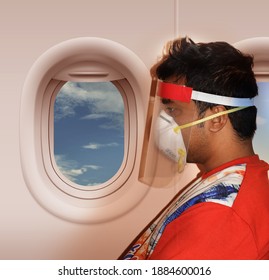 Covid Safety In Flight Or Airlines In India -  Indian Flight Passenger Sitting Inside An Aircraft Or Plane While Wearing Face Shield Mask Given By The Airlines To Prevent Against Corona Virus