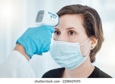 Covid, Thermometer And Doctor Scan Fever Temperature Of Woman With Mask Consulting In Hospital. Female Patient Test For Healthcare, Safety And Protection Against Coronavirus, Illness And Virus.