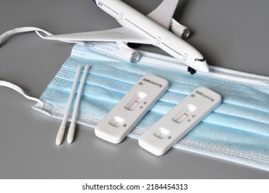 Covid Travel Safety Concept. Airplane On Protection Mask With Two SARS-CoV-2 Antigen Rapid Tests (Self Testing) Kits That Showing Negative Results.