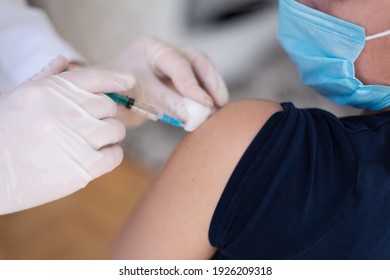 Covid Vaccine Injection By Doctor At Hospital. Doctor Making Injection Vaccination Patient To Prevent Pandemic Of The Disease, Flu Or Influenza Virus In Clinic