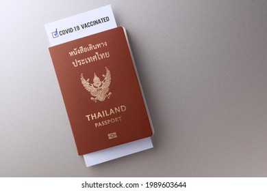 Covid Vaccine Passport And Health Record Card For Travelling. Top View Of Thailand Passport With Immnunity Certification Of Covid-19 Vaccinated By CDC