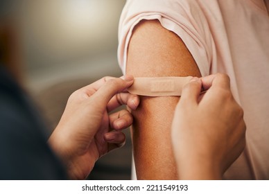 Covid, Vaccine And Plaster With A Doctor And Patient Consulting In An Appointment Or Checkup At Home. Nurse, Healthcare And Trust With A Health Professional Using A Bandaid On An Arm After Medication