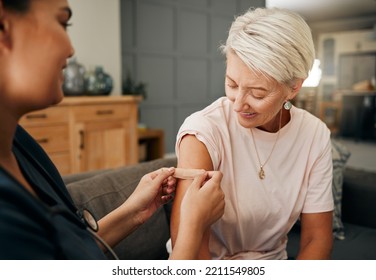 Covid vaccine, plaster and doctor with patient in a health consultation at a retirement house. Nurse, healthcare worker and elderly woman with a bandaid on her arm after a treatment in a nursing home - Powered by Shutterstock