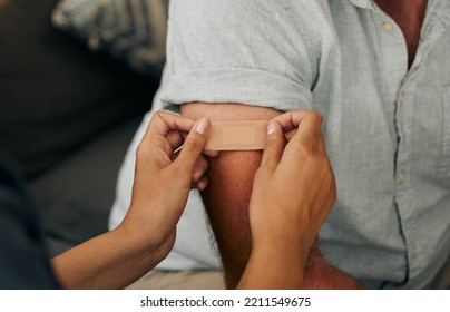 Covid, Vaccine And Plaster With Hands Of A Doctor Sticking A Bandaid On A Patient In The Hospital Or Clinic. Healthcare, Medicine And Trust With A Female Nurse Consulting With A Man For Health