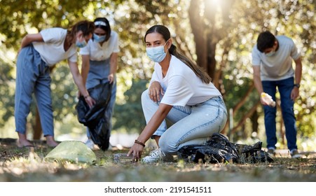 Covid, Volunteer And Charity With A Young Woman Doing Community Service And Cleaning Up The Environment With People In The Background. Portrait Of An Eco Friendly Environmentalist Picking Up Trash