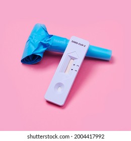 A Covid-19 Antigen Diagnostic Test Device And A Blue Party Horn On A Pink Background, As A Safe Party Set