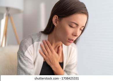 COVID-19 breathing difficulties woman with shortness of breath Coronavirus cough breathing problem. Asian girl in pain touching chest respiratory symptoms fever, coughing, body aches.