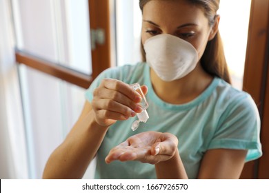 COVID-19 Close up woman wash hand sanitizer gel dispenser, against Novel coronavirus (2019-nCoV) at home. Home isolation, Auto Quarantine, Antiseptic, Hygiene and Healthcare concept. Focus on hand. - Powered by Shutterstock