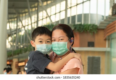 Covid-19 Concept.Little Chinese Boy With Mother Wearing Disposal Mask For Protect From Coronavirus For Back To School.School Kid Go To School With Mom.New Normal Lifestyle.