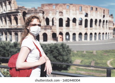 COVID-19 Corona Virus In Europe. Travel, Tourism And Lockdown Concept. Girl Tourist Wearing Face Mask Next To Empty Colosseum, Rome, Italy. World Landmarks, Museums Closed Due To COVID19 Coronavirus.