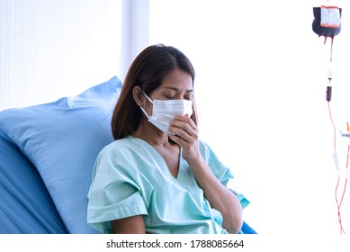 COVID-19, Corona Virus Outbreak, Quarantine And Epidemic Spread Concept. Asian Depressed CORONA Or COVID-19 Patient Infection Wear Mask And Get Blood Transfusion In Quarantine Room At The Hospital