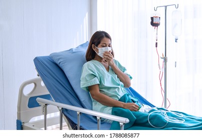 COVID-19, Corona Virus Outbreak, Quarantine And Epidemic Spread Concept. Asian Depressed CORONA Or COVID-19 Patient Infection Wear Mask And Get Blood Transfusion In Quarantine Room At The Hospital