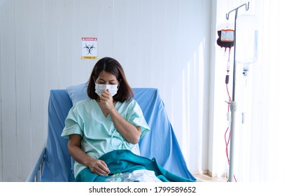 COVID-19, Corona Virus Outbreak, Quarantine And Epidemic Spread Concept. Asian Depressed CORONA Or COVID-19 Patient Infection Wear Mask And Get Blood Transfusion In Quarantine Room At The Hospital