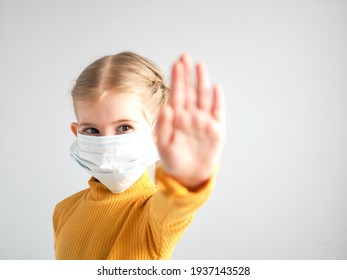 Covid-19. Coronavirus Concept. Little Girl Child Wearing Mask For Protection From Disease And Showing Stop Hands Gesture For Stop Coronavirus Outbreak. Stay Home. Social Distancing