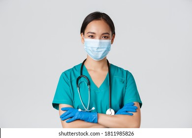 Covid-19, coronavirus disease, healthcare workers concept. Close-up of confident smiling, professional asian doctor, nurse in medical mask and rubber gloves ready for examination, white background - Powered by Shutterstock