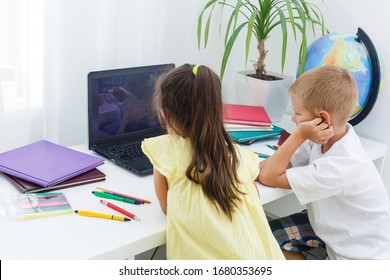 Covid-19 Coronavirus And Learning From Home, Home School Kid Concept. Little Children Study Online Learning From Home With Laptop. Quarantine And Social Distancing Concept.