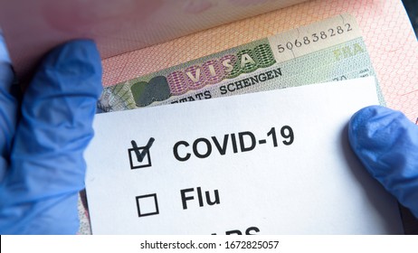 COVID-19 Coronavirus Pandemic And Travel Concept, Positive Mark COVID And Schengen Visa Stamp. Passport Control Of Tourists With Coronavirus Check. Novel Corona Virus Outbreak, Epidemic In Europe.