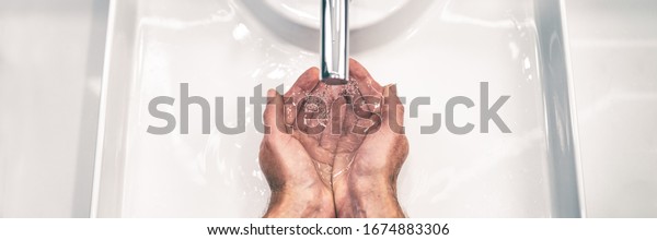 COVID-19\
Coronavirus prevention washing hands with soap at bathroom sink man\
hand hygiene for corona virus pandemic precaution by washing hands\
frequently for 20 seconds. Panoramic\
banner.