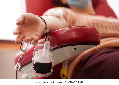 COVID-19 Coronavirus Survivor Patient Donating Convalescent PRP Blood Plasma, Platelet Rich AB Plasma Female Donor Sitting In Chair, Blood Drip Filling Bag, SARS-CoV-2 Therapy Treatment And Cure