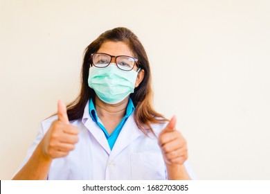 Covid19 Coronavirus Symptoms.Indian Doctor Wearing Surgical Mask For Protect From Coronavirus Covid-19 In India Show Thumb Up Gesture And Fight Covid-19 Virus Outbreak.coronavirus Pandemic Symptoms.