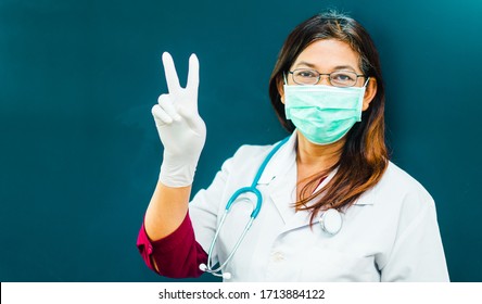 Covid19 Coronavirus Symptoms.Indian Doctor Wearing N95 Mask For Protect From Coronavirus Covid-19 In India Show Number Two Gesture And Fight Covid-19 Virus Outbreak.coronavirus Pandemic Symptoms.