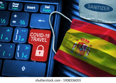  COVID-19 Coronavirus Travel Restrictions Concept Showing Red Button Warning On Keyboard With Spanish Flag Face Mask And Hand Sanitizer. New Normal In Global Travel.