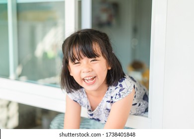 Covid-19 Coronavirus.Stay Home.home Care, Social Distancing.Happy Little Asian Kid Girl Laughing Showing Big Smile With Stay Strong At Home.Lockdown, Online Learn For Control Infection.Stay At Home.