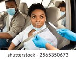 Covid-19 Diagnostic. Black Family Of Three Getting Tested For Coronavirus With Nasal PCR Test Sitting In Automobile, Wearing Protective Face Masks. Covid Pandemic Outbreak Concept