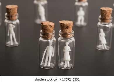 Covid-19 Epidemic, Protection Of Older And More Vulnerable People, Concept. Elderly Couple Figures Inside A Glass Bottle