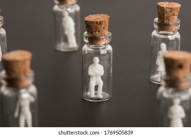 Covid-19 Epidemic, Protection Of Older And More Vulnerable People, Concept. Elderly Couple Figures Inside A Glass Bottle