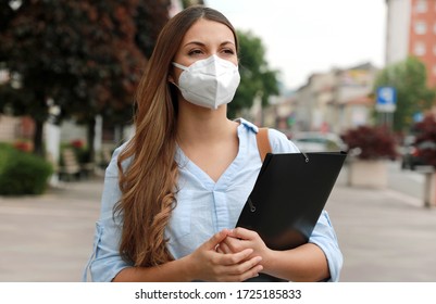 COVID-19 Global Economic Crisis Unemployed Worried Girl With Mask Looking For A Job Walking In City Street Delivering Curriculum Vitae