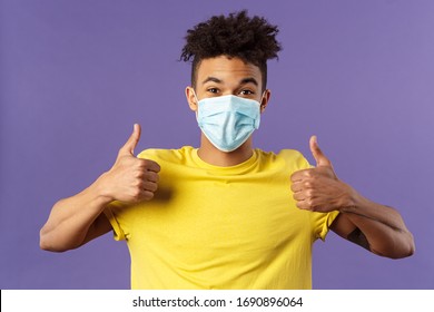 Covid19, Healtcare And Medicine Concept. Enthusiastic Happy Spanish Guy In Facial Mask, Show Thumbs-up And Smiling With Eyes, Excited, Support Social-distancing, Prepared For Going Grocery Shopping