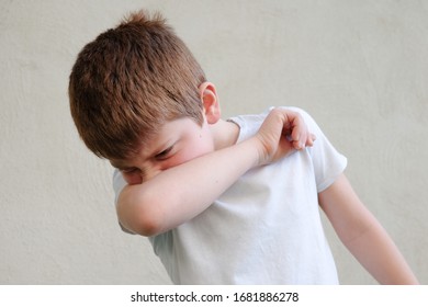 COVID-19 Kids Sneezing Into Arm Covering Mouth And Nose While Coughing Flu. Coronavirus Protection Prevention 