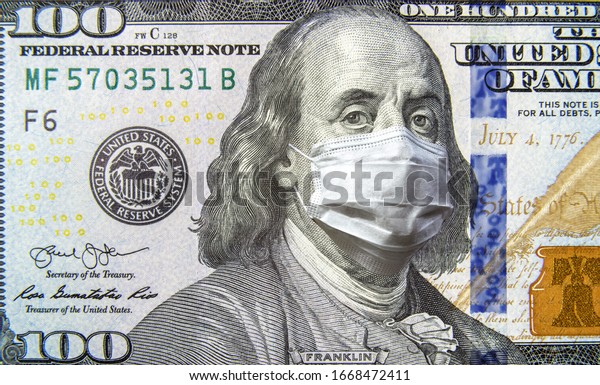 COVID-19 and money, 100 dollar bill with face\
mask. Coronavirus affects global stock market. World economy hits\
by corona virus outbreak and pandemic fears. Crisis, USA, recession\
and finance concept