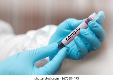 COVID-19 Named By WHO For Novel Coronavirus NCP Concept. Doctor Or Lab Technician In PPE Suit Holding Blood Sample With Novel (new) Coronavirus  In Wuhan, Hubei Province, China, Medical And Healthcare