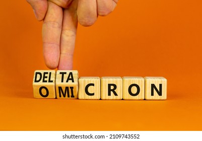 Covid-19 omicron or deltacron symbol. Doctor turns cubes and changes the word omicron to deltacron. Beautiful orange background. Medical, covid-19 corona omicron or deltacron concept. Copy space. - Shutterstock ID 2109743552
