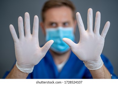 COVID-19 Out Break. Doctor Wearing PPE Showing Hands In Stop Gesture. Saty Home And Stop The Spread Of The Coronavirus Disease.