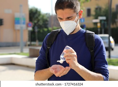 COVID-19 Pandemic Coronavirus Close up Man with KN95 FFP2 Mask using Alcohol Gel Sanitizer Hands in City Street. Antiseptic, Hygiene and Healthcare concept. - Powered by Shutterstock