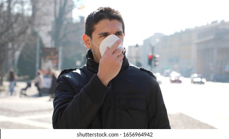 COVID-19 Pandemic Coronavirus Man in city street wearing face mask protective for spreading of Coronavirus Disease 2019. Portrait of man with face mask against SARS-CoV-2. - Powered by Shutterstock