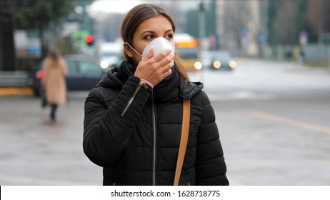 COVID-19 Pandemic Coronavirus Woman in city street wearing protective face mask for spreading of disease virus SARS-CoV-2. Girl with protective mask on face against Coronavirus Disease 2019. - Shutterstock ID 1628718775